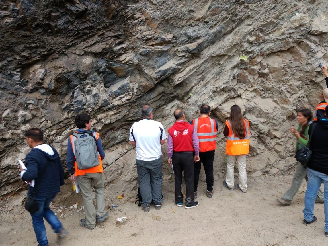 Participants studying Himalayan rock formations in the field