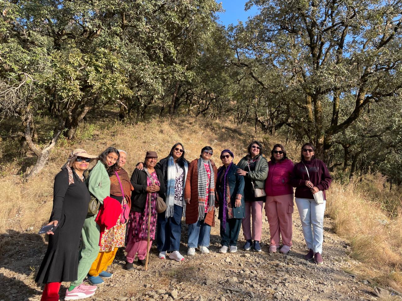 A group walking together through a Himalayan forest landscape