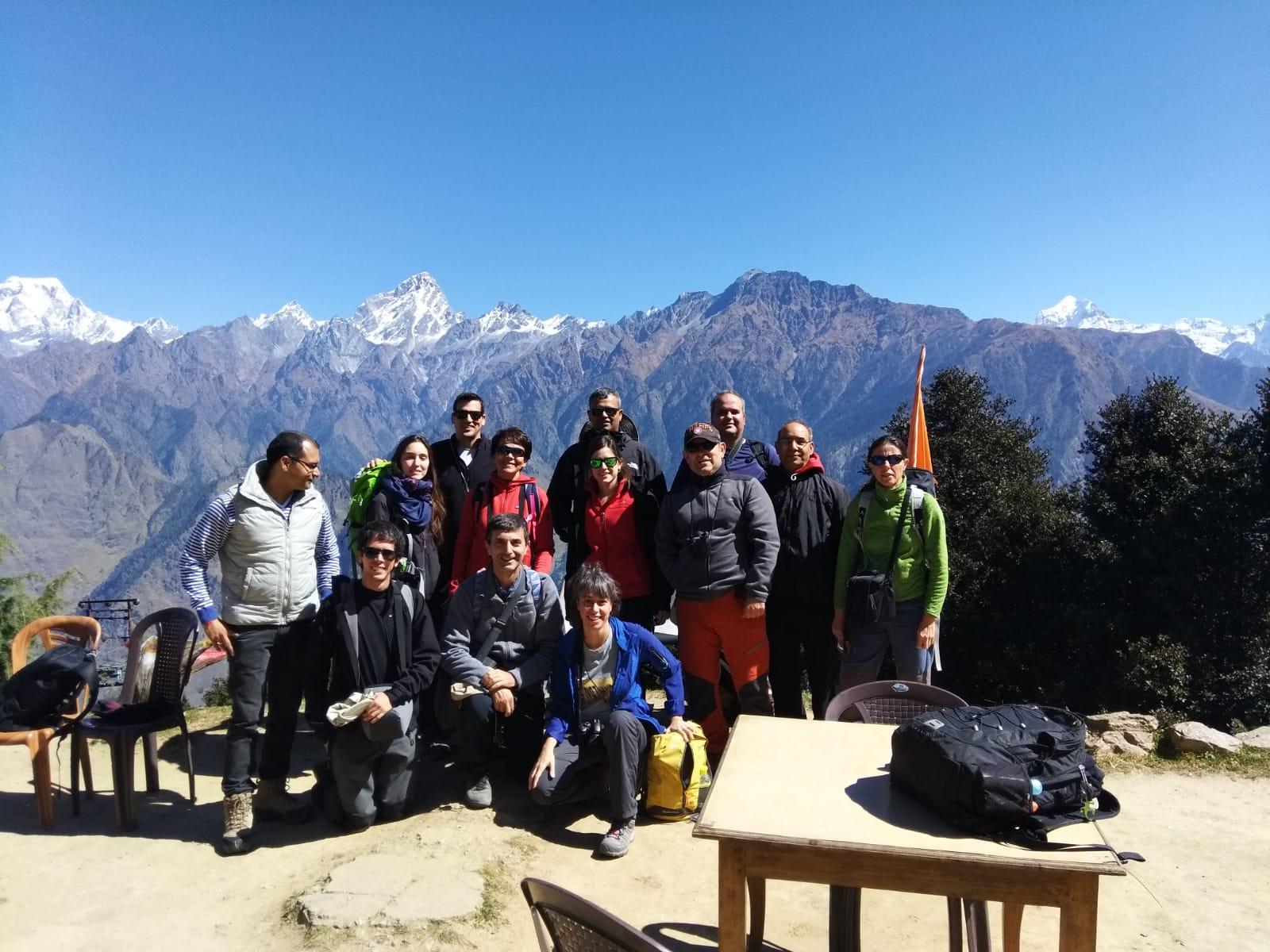 A Travel Tribes group gathered before a Himalayan snow-peak panorama