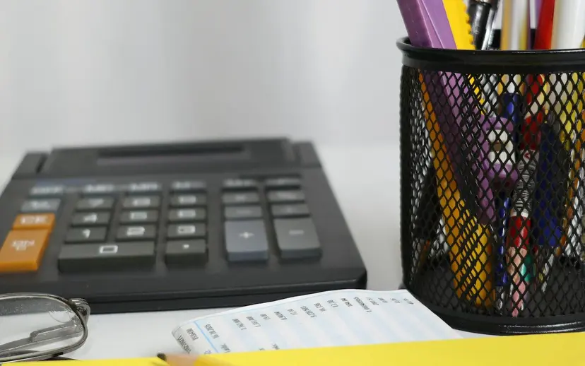 Calculator and price bid sheet being filled for a tender