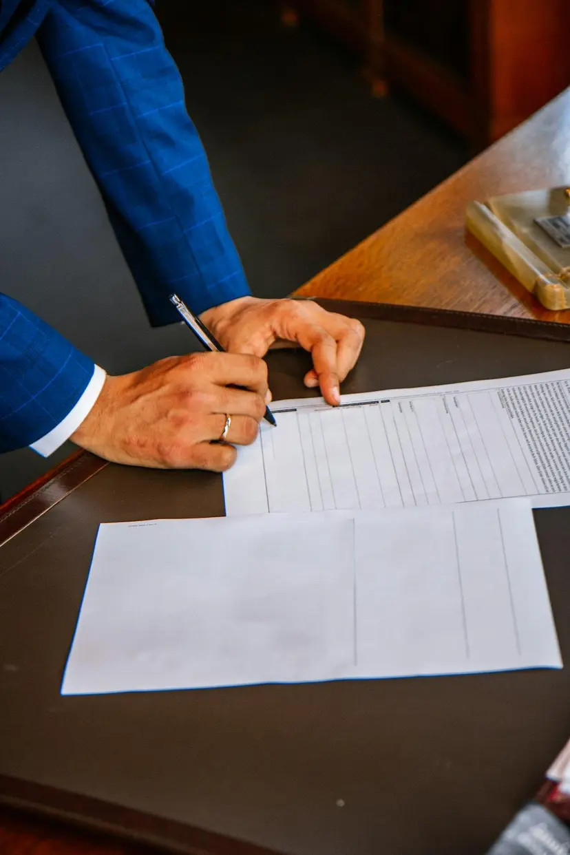Company stamp and signature being applied to tender documents
