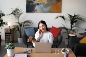 Remote team working from home in different locations, connected through a virtual meeting, representing a fully remote work model without a central office.