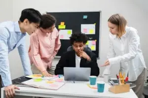 Hybrid team collaborating to solve workplace challenges, with in-office members and remote participants working together in a connected meeting.