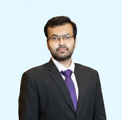 Portrait of Venkata Naveen Damaraju in a dark suit and light blue shirt