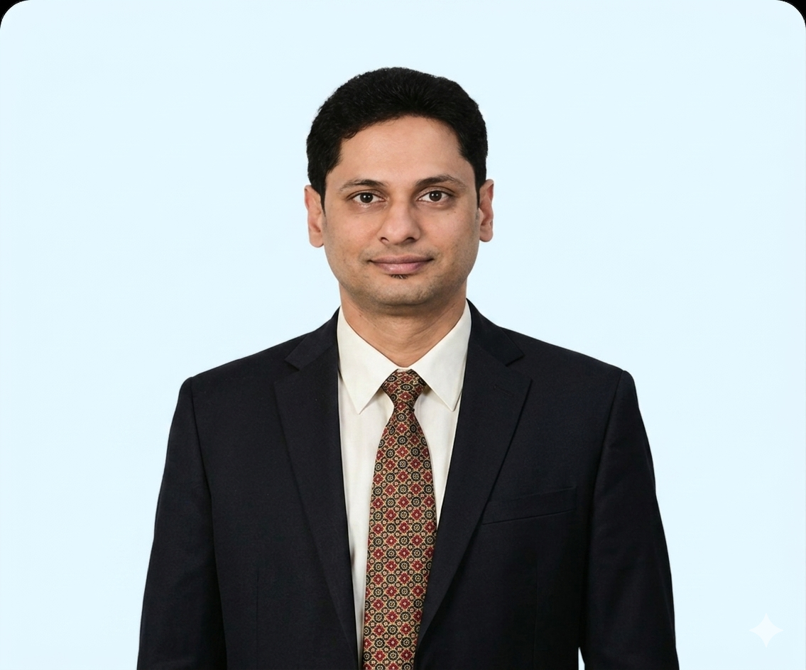 Portrait of Venkata Naveen Damaraju in a dark suit and light blue shirt